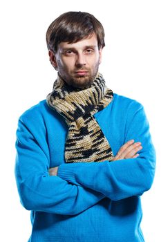 Young man wearing a scarf and a sweater folded his arms across his chest