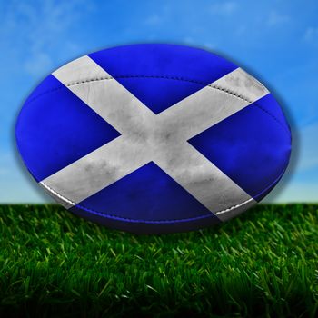 Rugby ball with Scotland flag over grass