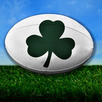 Rugby ball with Irish Shamrock over grass