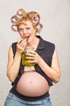 Young pregnant single female in curlers and jeans