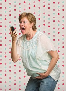 Pretty young pregnant woman on polka dot background