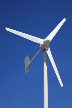 a wind turbine for renewable energy on a background of blue sky