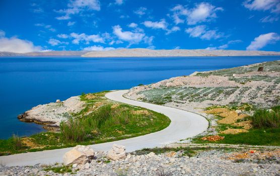 dalmatian part of the Adriatic coast and rocky beach, with blue sky  in Pag in Croatia.
