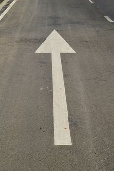 arrow signs on the asphalt road