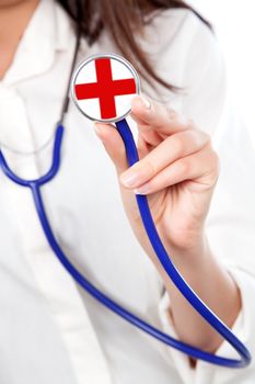 Closeup of a female doctor holding out a stethoscope to the camera