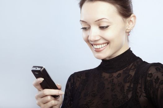 Smiling lady reading or sending SMS 