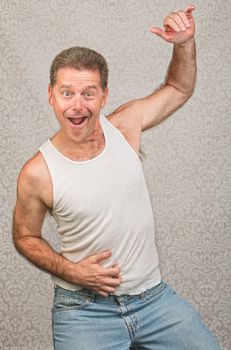 Dancing Caucasian man in blue jeans and undershirt