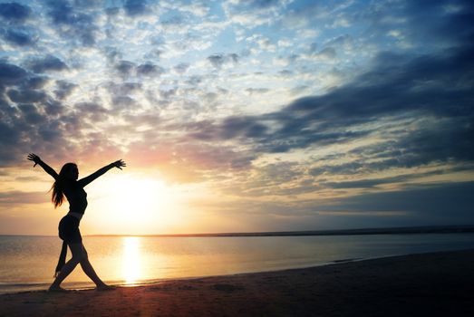 Moving healthy lady at the beach during sunset