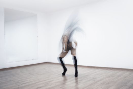 Motion blur of the woman performing dance in ball room