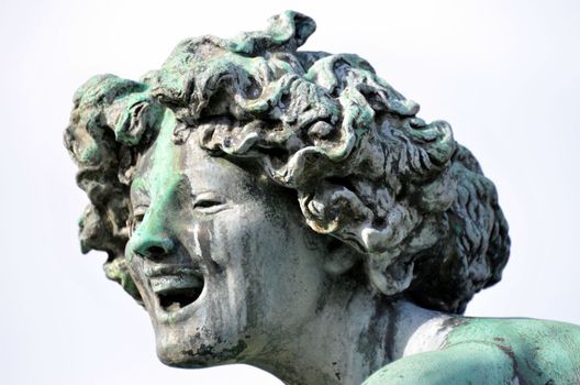 A head of a sculpture in a park in Antwerp.