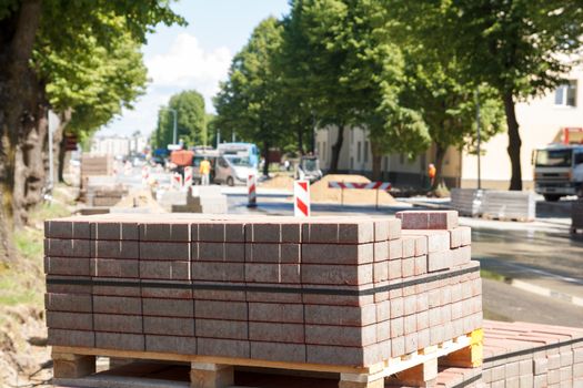 road repair. pile of bricks and road works in the background