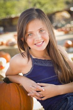 Preteen Girl Portrait at the Pumpkin Patch in a Rustic Setting.