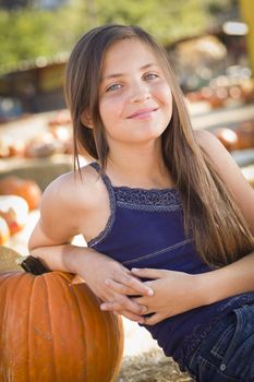 Preteen Girl Portrait at the Pumpkin Patch in a Rustic Setting.