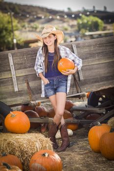 Preteen Girl Wearing Cowboy Hat Portrait at the Pumpkin Patch in a Rustic Setting.