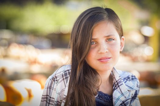 Preteen Girl Portrait at the Pumpkin Patch in a Rustic Setting.