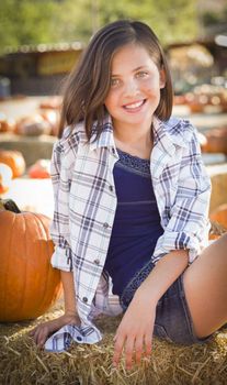 Preteen Girl Portrait at the Pumpkin Patch in a Rustic Setting.
