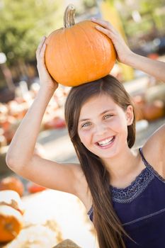 Preteen Girl Portrait at the Pumpkin Patch in a Rustic Setting.