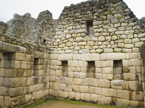 Made of Stone Interior in a room of Temple of the Sun in a pre-Columbian 15th-century Inca site of Machu Picchu in Cusco region, Peru.
