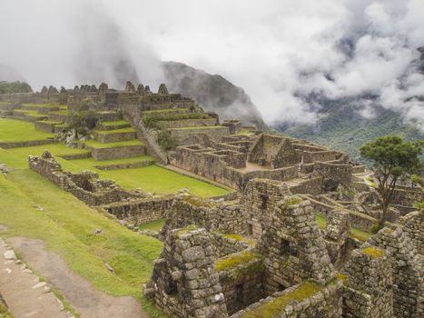 Ruins Buildings in Machu Picchu - Mysterious city and archaeological site of pre-Columbian civilization of the Incas on the Andes cordillera mountains archeology near Cusco, Peru.