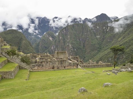 Ruins Buildings in Machu Picchu - Mysterious city and archaeological site of pre-Columbian civilization of the Incas on the Andes cordillera mountains archaeology near Cusco, Peru.