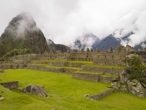 Ruins Buildings in Machu Picchu - Mysterious city and archaeological site of pre-Columbian civilization of the Incas on the Andes cordillera mountains archaeology near Cusco, Peru.