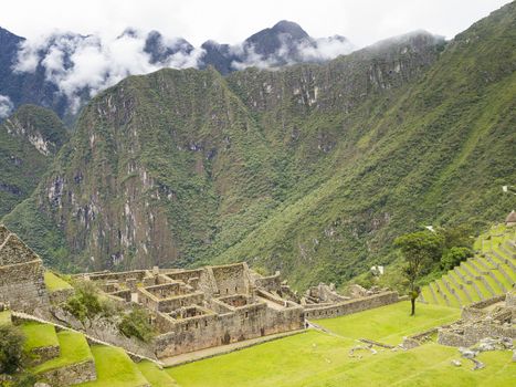 Ruins Buildings in Machu Picchu - Mysterious city and archaeological site of pre-Columbian civilization of the Incas on the Andes cordillera mountains archaeology near Cusco, Peru.