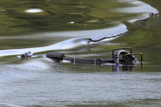 Oil pump soaked in crude oil spilled on the beach of Thailand