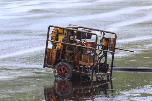 Oil pump evacuate crude oil spilled on the beach in Thailand.