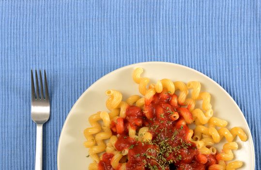 pasta with tomato sauce on blue