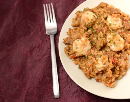 Shrimp jambalaya creole food on a burgundy table cloth