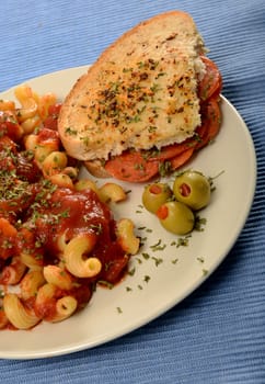 italian cuisine with salami sandwich and pasta