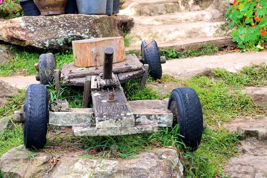 Old wooden rustic toy car on a garden background