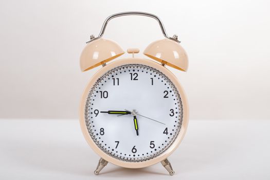 Alarm clock on a table on white table