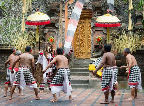 UBUD, BALI, INDONESIA - SEP 21: Kris-wielding dancers fight with Rangla on traditional balinese Barong dance performance on Sep 21, 2012 in Ubud, Bali, Indonesia. The show is popular tourist attraction on Bali