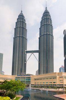 KUALA LUMPUR - JUN 15: Petronas Towers and Symphony lake on Jun 15, 2013 in Kuala Lumpur, Malaysia. The towers were the tallest buildings in the world from 1998 to 2004  (451.9 m). 