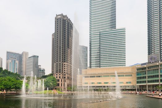 KUALA LUMPUR - JUN 15: Lake Symphony fountain near Petronas Towers on Jun 15, 2013 in Kuala Lumpur, Malaysia. Lake Symphony is a 10,000 square meter man made lake with water fountains. 