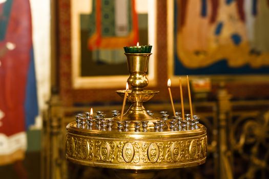 Orthodox Church and the interior, a cross and candles during worship