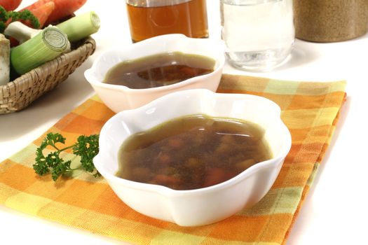 Beef Consomme in a bowl on light background