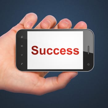 Business concept: hand holding smartphone with word Success on display. Generic mobile smart phone in hand on Dark Blue background.