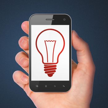 Business concept: hand holding smartphone with Light Bulb on display. Generic mobile smart phone in hand on Dark Blue background.