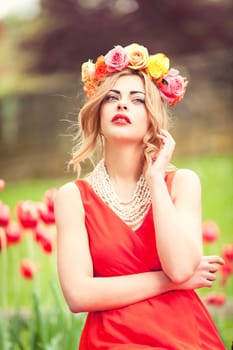 beautiful woman portrait outdoor with colorful flowers and red lips