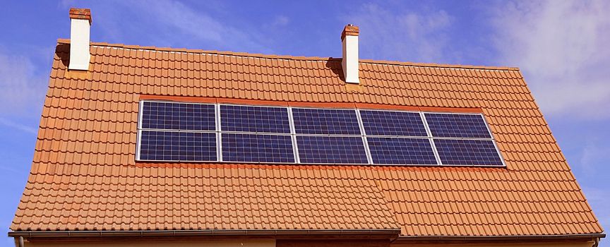 photovoltaic or solar panels on a roof of house
