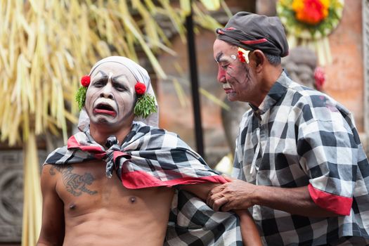 BALI - SEP 21: Clown Barong and Kris Dance performs at Sahadewah, in Batubulan, Bali, Indonesia on Sep 21, 2012. This famous play represents an fight between good and bad gods.