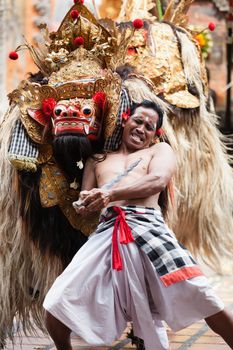 BALI - SEP 21: Barong and Kris Dance performs at Sahadewah, in Batubulan, Bali, Indonesia on Sep 21, 2012. This famous play represents an fight between good and bad gods.