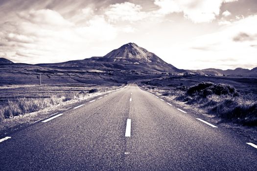 road to the Errigal mountains in county Donegal Ireland on a bright cloudy day toned