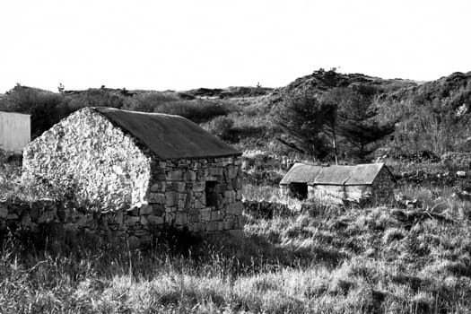old rustic stone buildings in county Donegal Ireland in black and white