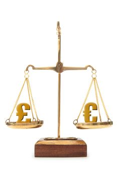 Euro and pound symbols balanced on weighing scales 