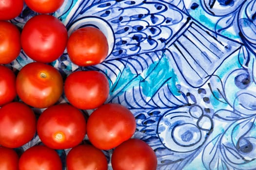 Ripe cherry tomatoes on a blue plate