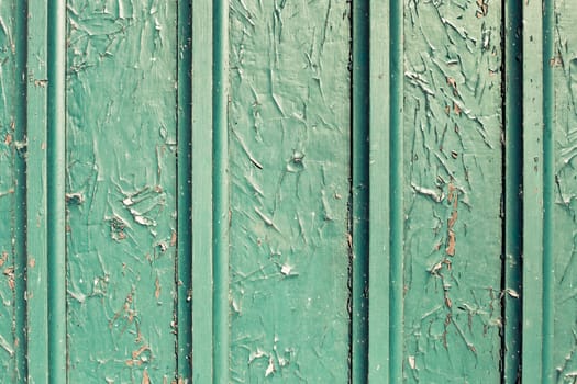 Peeling paint on a wooden surface as a background