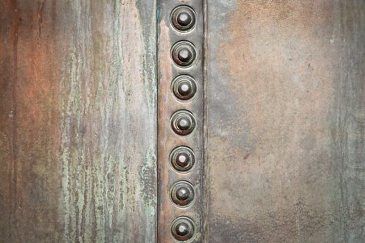 Grungy metal background with nuts and bolts